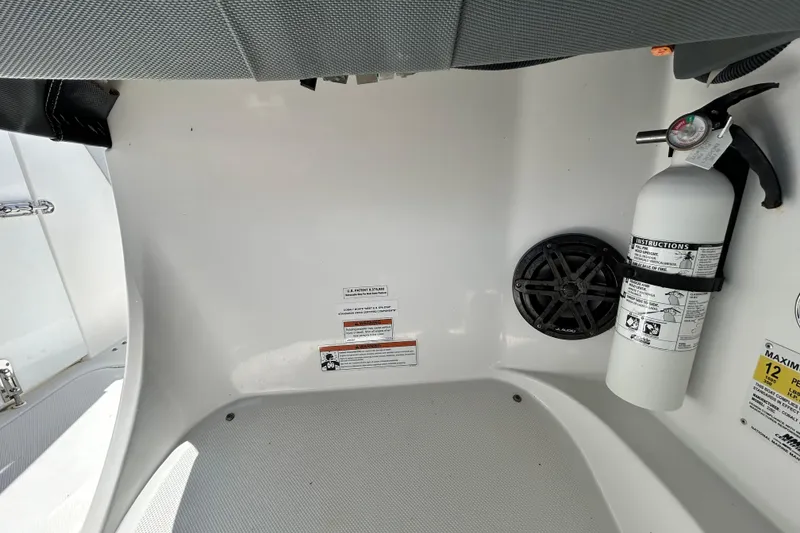 Slide: The Image of Interior of 2020 Cobalt 23SC boat with fire extinguisher and speaker. - 49