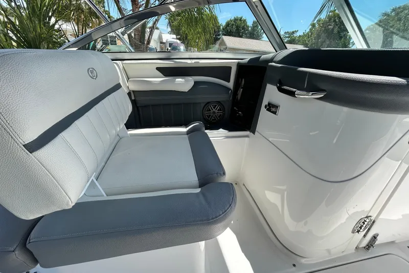 Slide: The Image of Interior of a 2020 Cobalt 23SC boat, featuring sleek white and gray seating. - 50