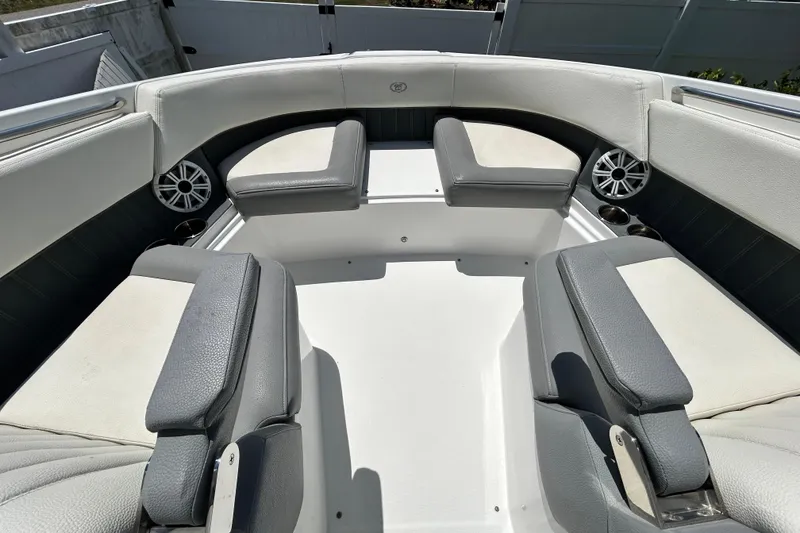 Slide: The Image of 2020 Cobalt 23SC boat interior with cushioned seating and built-in speakers. - 62