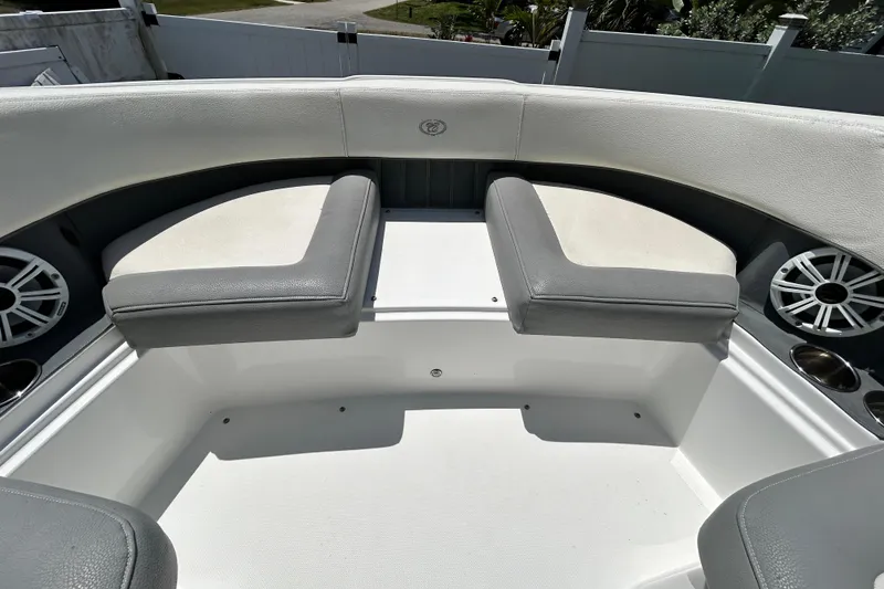 Slide: The Image of 2020 Cobalt 23SC boat interior with cushioned seating and speakers. - 63
