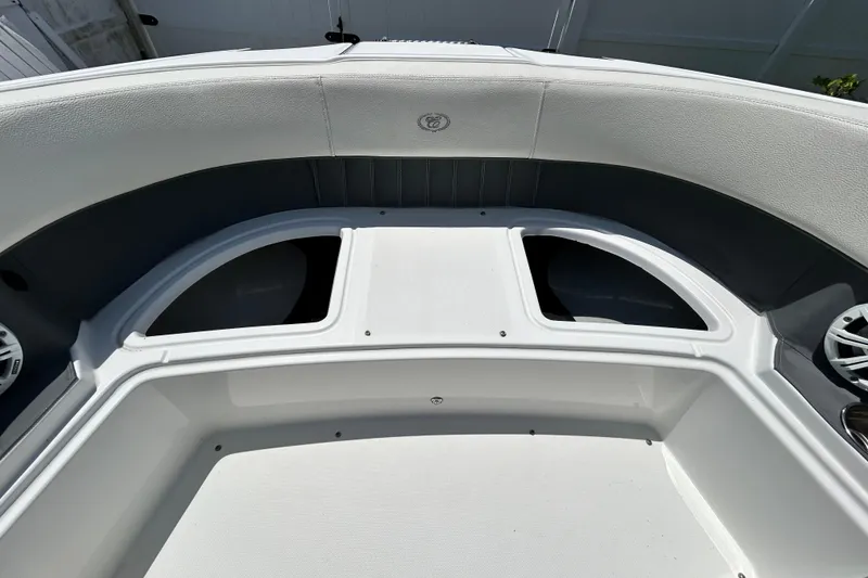 Slide: The Image of 2020 Cobalt 23SC boat interior with white seating and storage compartments. - 66