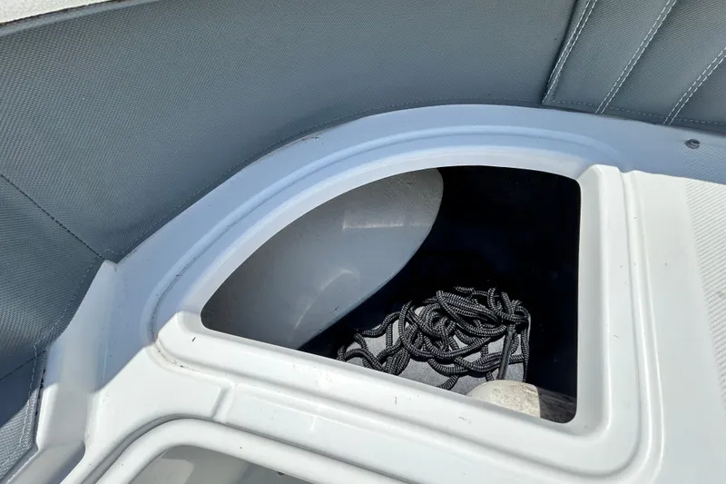 Slide: The Image of Storage compartment in a 2020 Cobalt 23SC boat with coiled rope inside. - 68