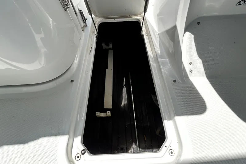 Slide: The Image of Open storage compartment on a 2020 Cobalt 23SC boat, showcasing interior space. - 71
