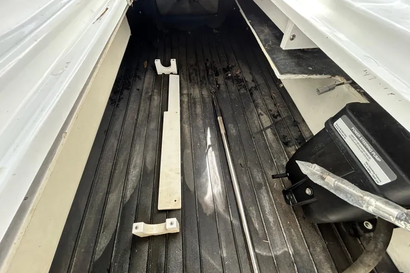 Slide: The Image of Interior view of a 2020 Cobalt 23SC boat showing components and power steering pump. - 72
