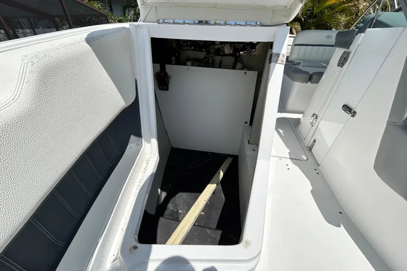 Slide: The Image of 2020 Cobalt 23SC boat interior storage compartment with white and gray seating. - 78
