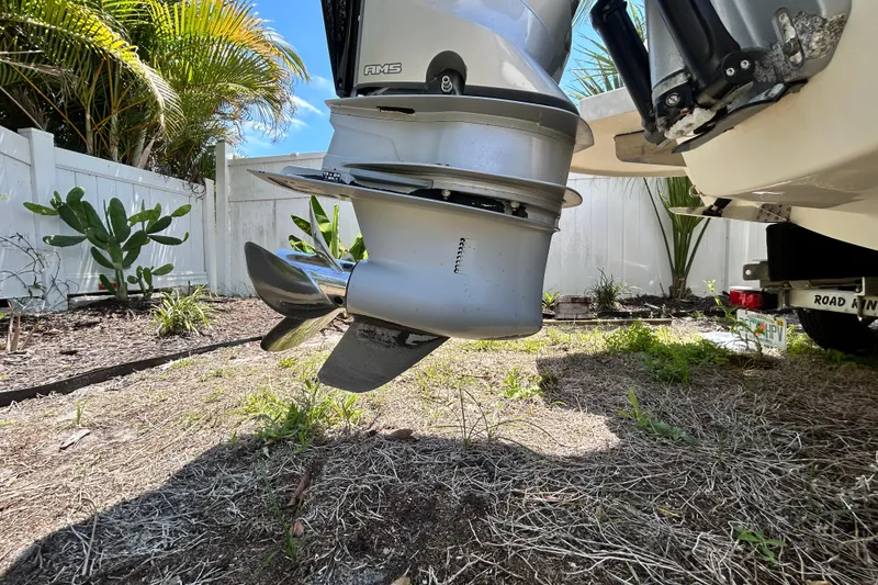 Slide: The Image of Outboard motor of a 2020 Cobalt 23SC boat, parked in a garden setting. - 8