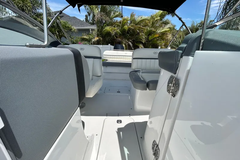 Slide: The Image of 2020 Cobalt 23SC boat interior with seating, under a sunny sky. - 82