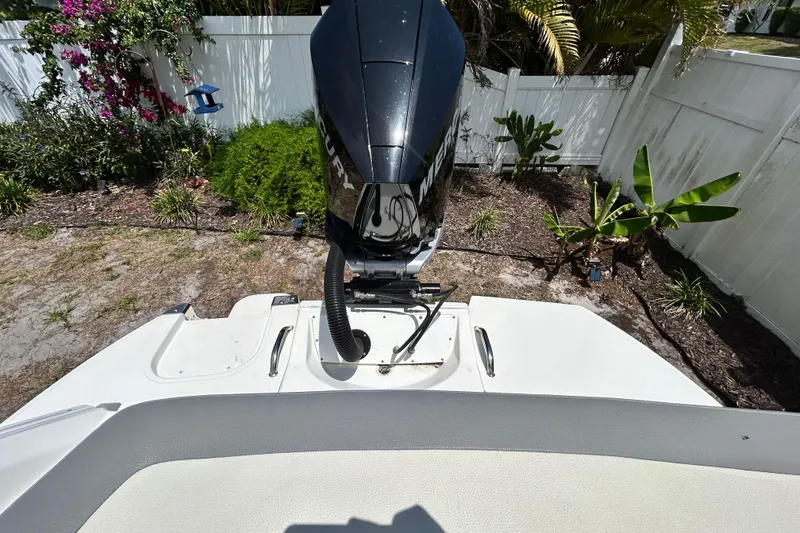 Slide: The Image of 2020 Cobalt 23SC boat with Mercury outboard motor in a garden setting. - 97