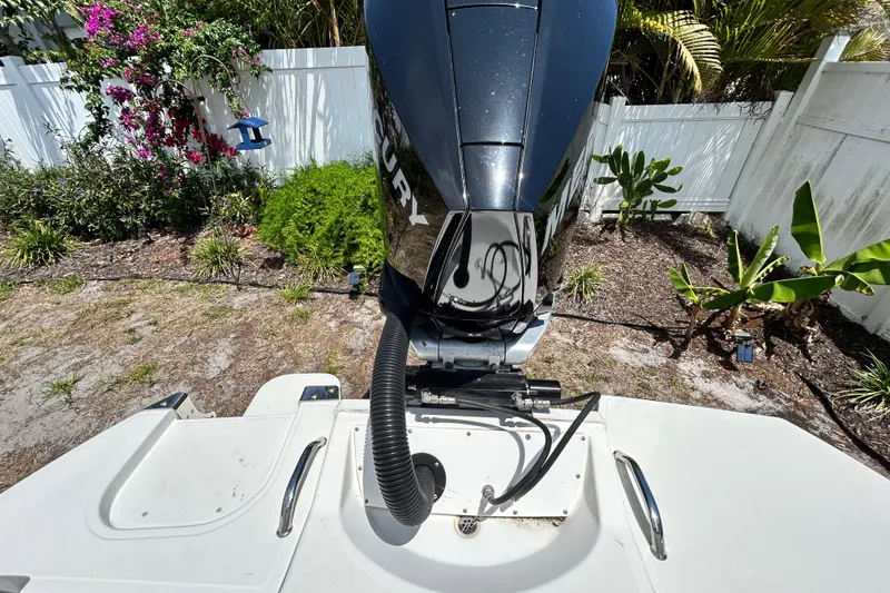 Slide: The Image of 2020 Cobalt 23SC boat with Mercury outboard motor in a garden setting. - 98