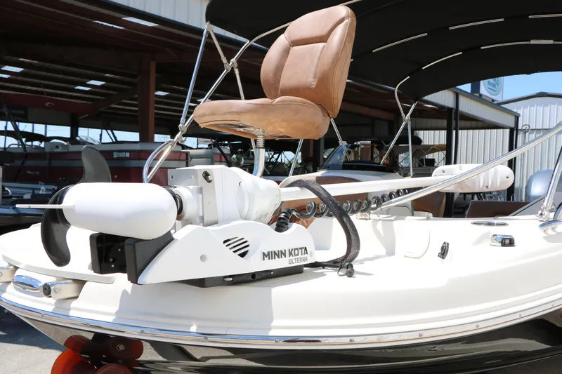 Slide: The Image of 2020 Stingray 192 SC boat with Minn Kota Ulterra motor and brown captain's chair. - 10