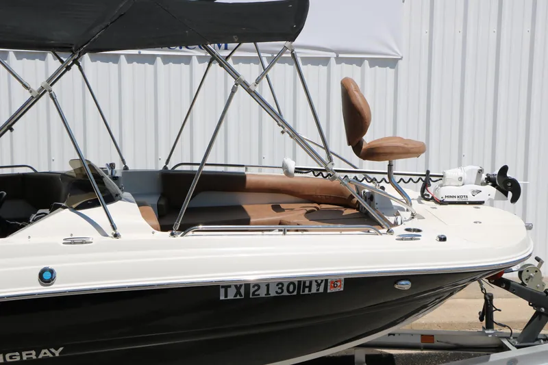 Slide: The Image of 2020 Stingray 192 SC boat with canopy and seating, displayed on a trailer. - 19