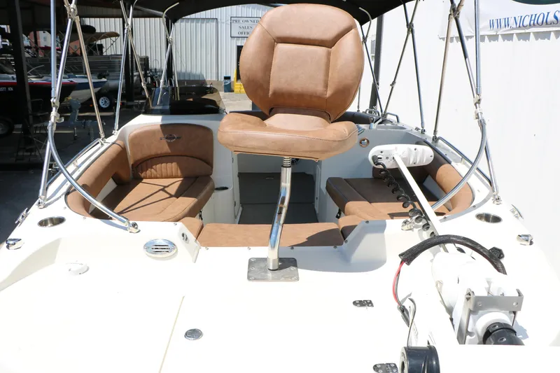 Slide: The Image of 2020 Stingray 192 SC boat interior with tan seating and steering console. - 20