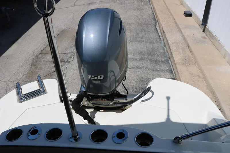 Slide: The Image of 2020 Stingray 192 SC boat with Yamaha 150 outboard motor, docked on concrete surface. - 26