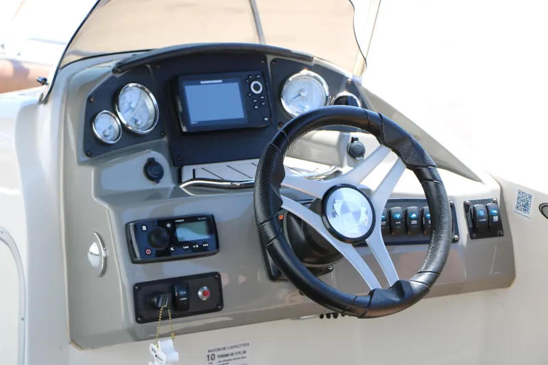 Slide: The Image of 2020 Stingray 192 SC boat dashboard with steering wheel and control panel. - 30