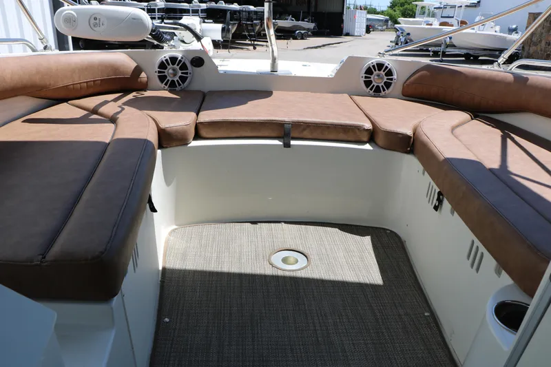 Slide: The Image of 2020 Stingray 192 SC boat interior with brown cushioned seating and speakers. - 33