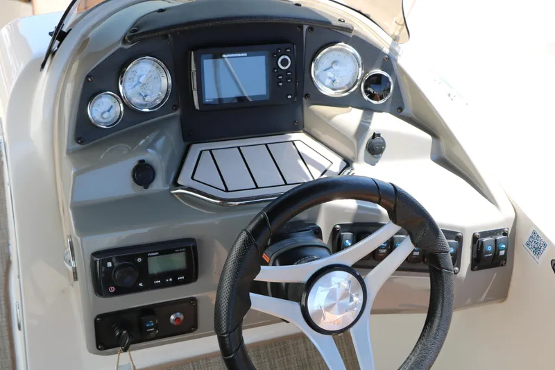 Slide: The Image of Dashboard of a 2020 Stingray 192 SC boat with steering wheel and gauges. - 36