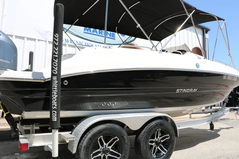 Slide: The Image of 2020 Stingray 192 SC boat on trailer, black and white design, displayed outdoors. - 4