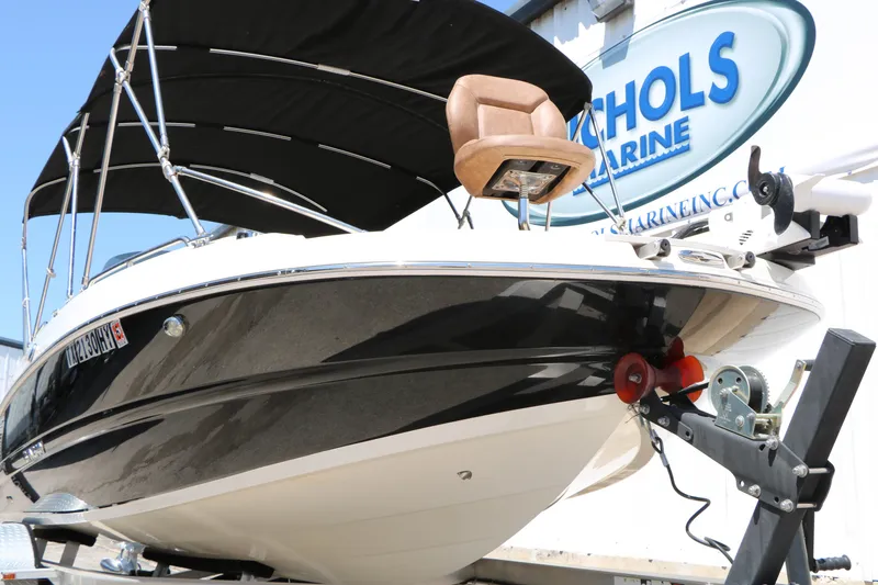Slide: The Image of 2020 Stingray 192 SC boat with black canopy on trailer at Nichols Marine. - 8