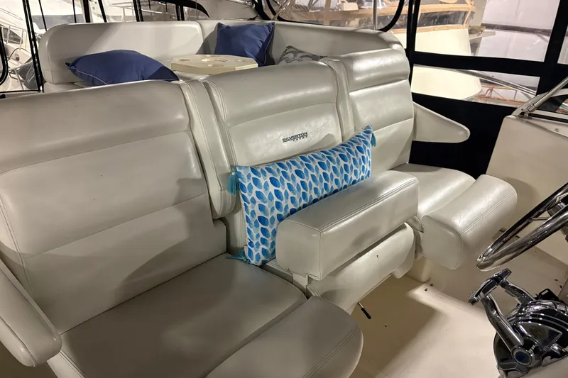 Slide: The Image of Interior of 2003 Silverton 43 Motor Yacht with white seating and blue cushions. - 10