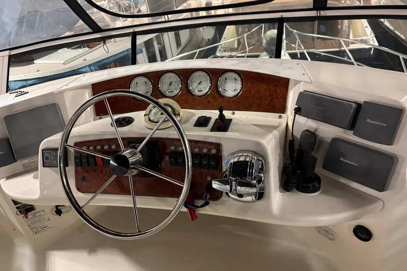 Slide: The Image of Helm of 2003 Silverton 43 Motor Yacht with steering wheel and navigation instruments. - 11