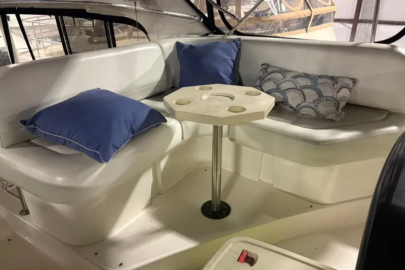 Slide: The Image of 2003 Silverton 43 Motor Yacht interior with cushioned seating and decorative pillows. - 13
