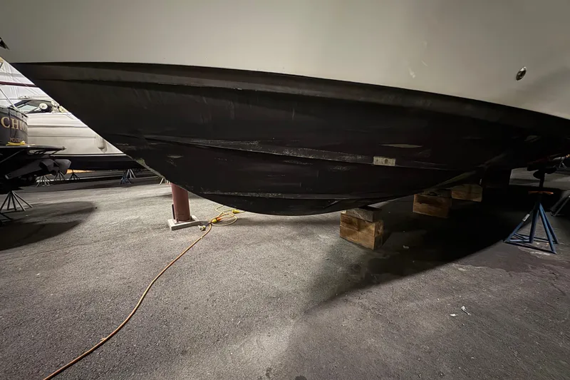 Slide: The Image of 2003 Silverton 43 Motor Yacht hull on blocks in storage facility. - 4