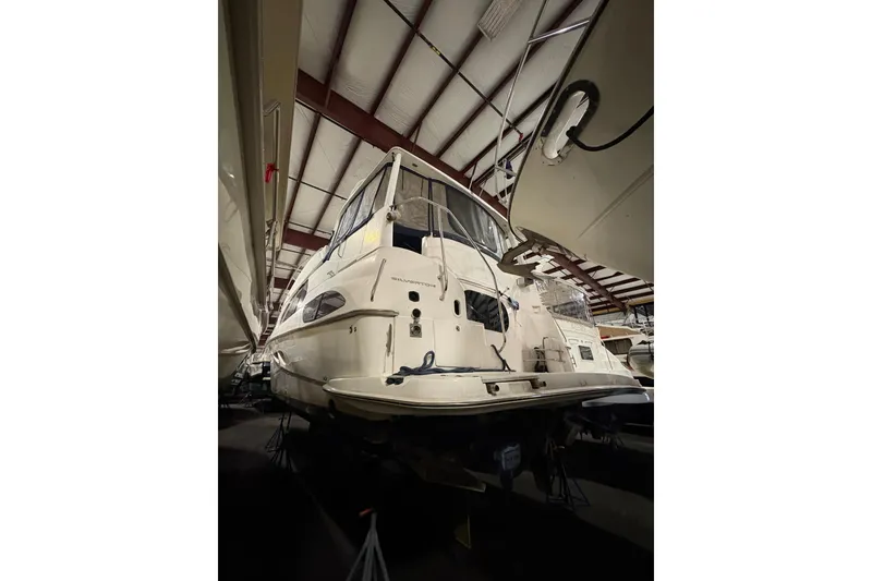 Slide: The Image of 2003 Silverton 43 Motor Yacht in storage, showcasing its sleek design and spacious deck. - 5