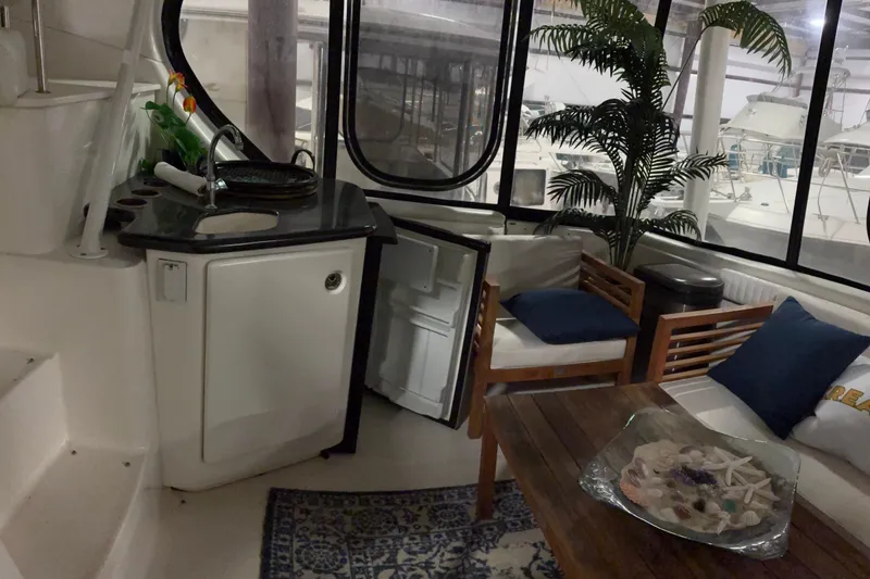 Slide: The Image of Interior of a 2003 Silverton 43 Motor Yacht with cozy seating and kitchenette. - 8