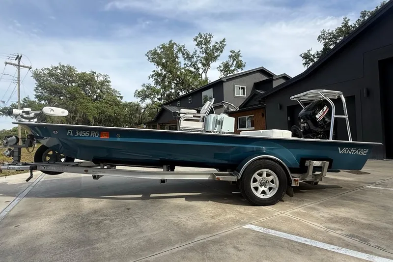 The Image of 2017 East Cape Vantage boat on trailer, parked outdoors near modern building. - 0