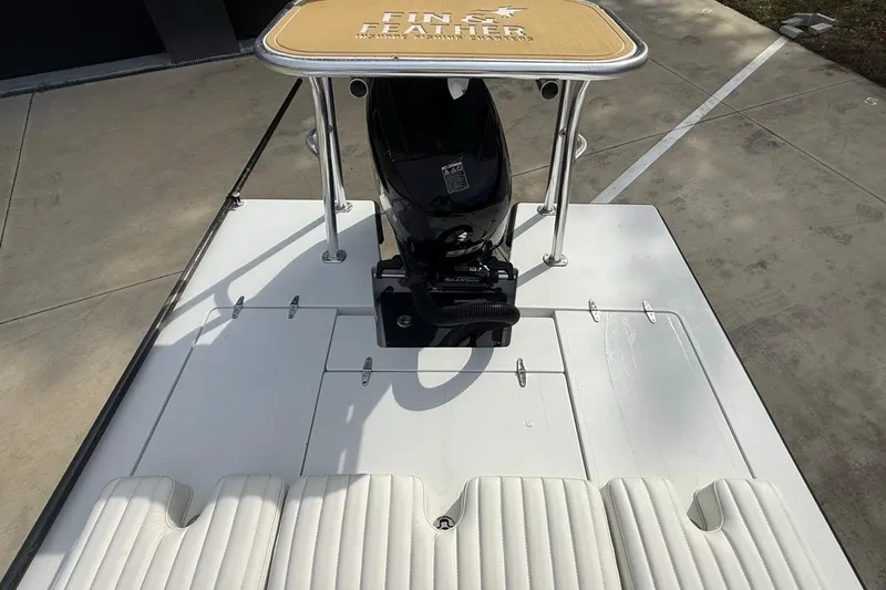 Slide: The Image of 2017 East Cape Vantage boat with motor and padded seating on a concrete surface. - 14
