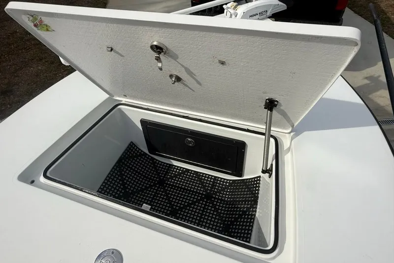 Slide: The Image of Open storage compartment on a 2017 East Cape Vantage boat, featuring a secure latch system. - 21