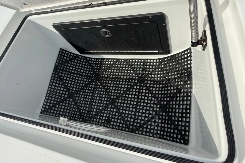 Slide: The Image of Storage compartment of a 2017 East Cape Vantage boat with black grid mat. - 22