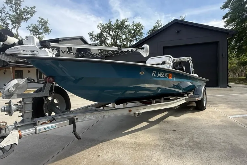 Slide: The Image of 2017 East Cape Vantage boat on trailer, parked in driveway near garage. - 4