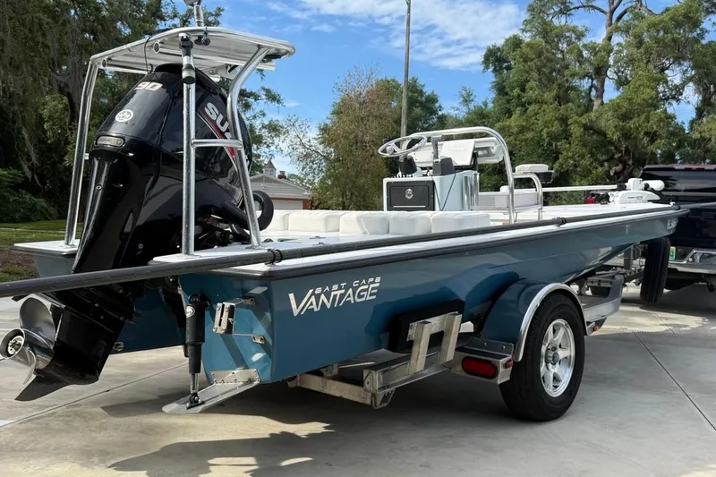Slide: The Image of 2017 East Cape Vantage boat on trailer with Suzuki outboard motor, parked outdoors. - 7