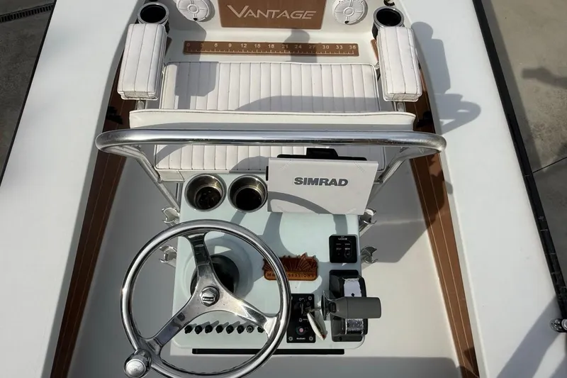 Slide: The Image of Cockpit view of a 2017 East Cape Vantage boat with steering wheel and Simrad electronics. - 9