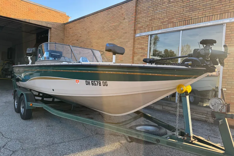 Slide: The Image of 2003 Crestliner 202 Tournament boat on trailer outside brick building. - 11