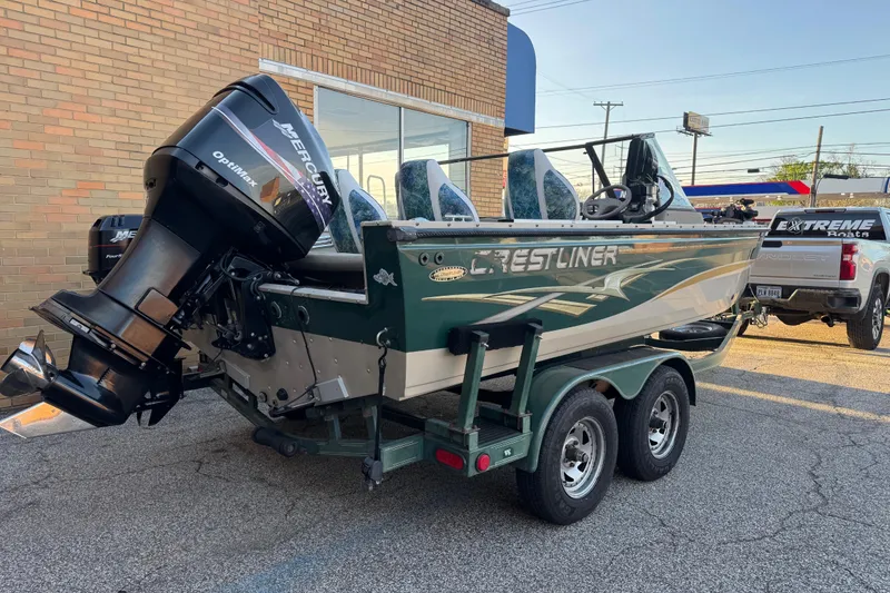 Slide: The Image of 2003 Crestliner 202 Tournament boat with Mercury Optimax engine on trailer. - 2