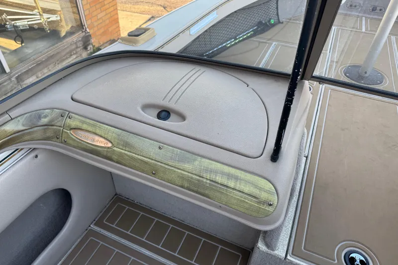 Slide: The Image of 2003 Crestliner 202 Tournament boat interior with wood accents and beige upholstery. - 22