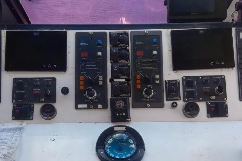 Slide: The Image of Control panel of a 2003 Gold Coast fast ferry with various gauges and switches. - 10