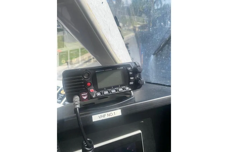 Slide: The Image of VHF radio on Gold Coast fast ferry, model 2003, with distress button visible. - 13