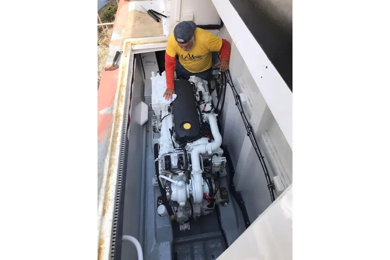Slide: The Image of Technician inspecting engine of 2003 Gold Coast fast ferry in maintenance area. - 19