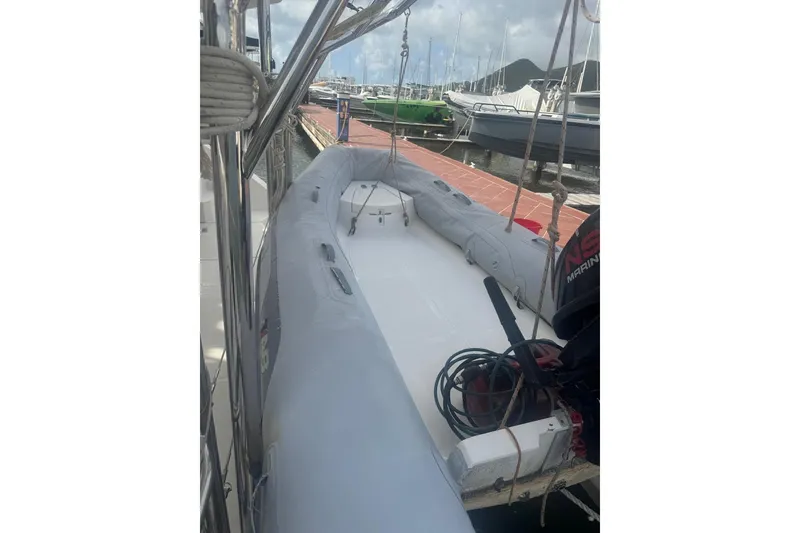 Slide: The Image of Inflatable boat docked at marina, featuring a 2003 Gold Coast fast ferry model. - 25