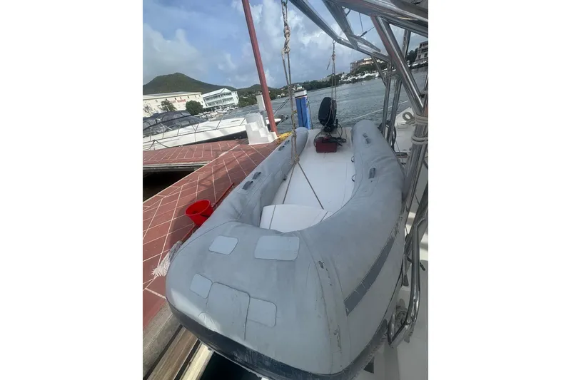 Slide: The Image of Inflatable boat docked near a Gold Coast fast ferry, 2003 model, at a marina. - 29