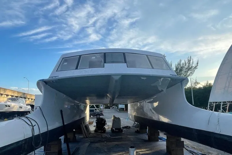 Slide: The Image of Gold Coast fast ferry from 2003 under maintenance, with clear sky background. - 3