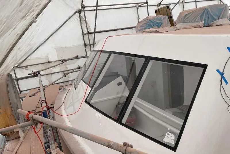 Slide: The Image of 2003 Gold Coast fast ferry under maintenance, covered in scaffolding and protective sheeting. - 33