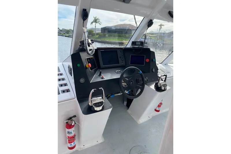 Slide: The Image of Cockpit of a 2003 Gold Coast fast ferry with steering wheel and control panels. - 36