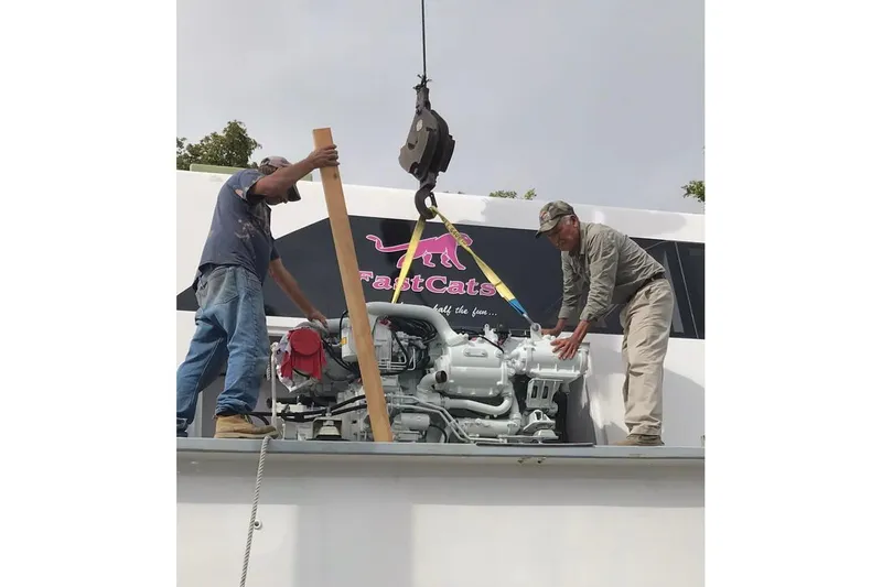 Slide: The Image of Two men installing an engine on a 2003 Gold Coast fast ferry. - 39