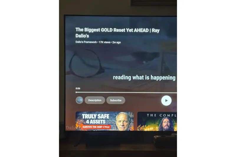 Slide: The Image of Television screen displaying a video titled "The Biggest GOLD Reset Yet AHEAD | Ray Dalio's." - 43