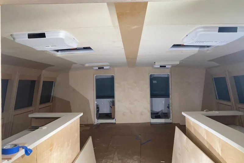 Slide: The Image of Interior of a 2003 Gold Coast fast ferry under construction, featuring unfinished wood paneling. - 9