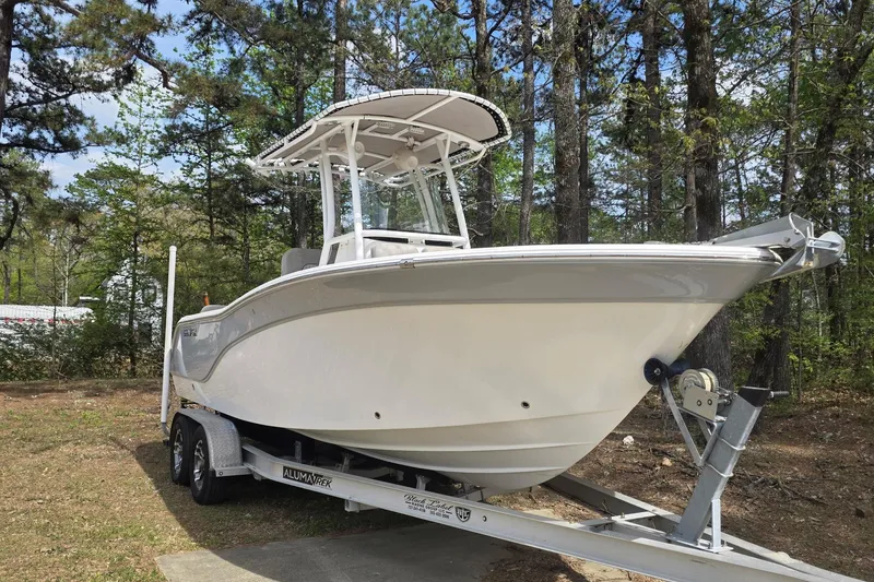 Slide: The Image of 2019 Sea Fox 226 Commander boat on trailer in wooded area. - 3